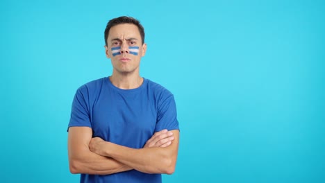 Dignified and serious man with salvadoran flag painted on face