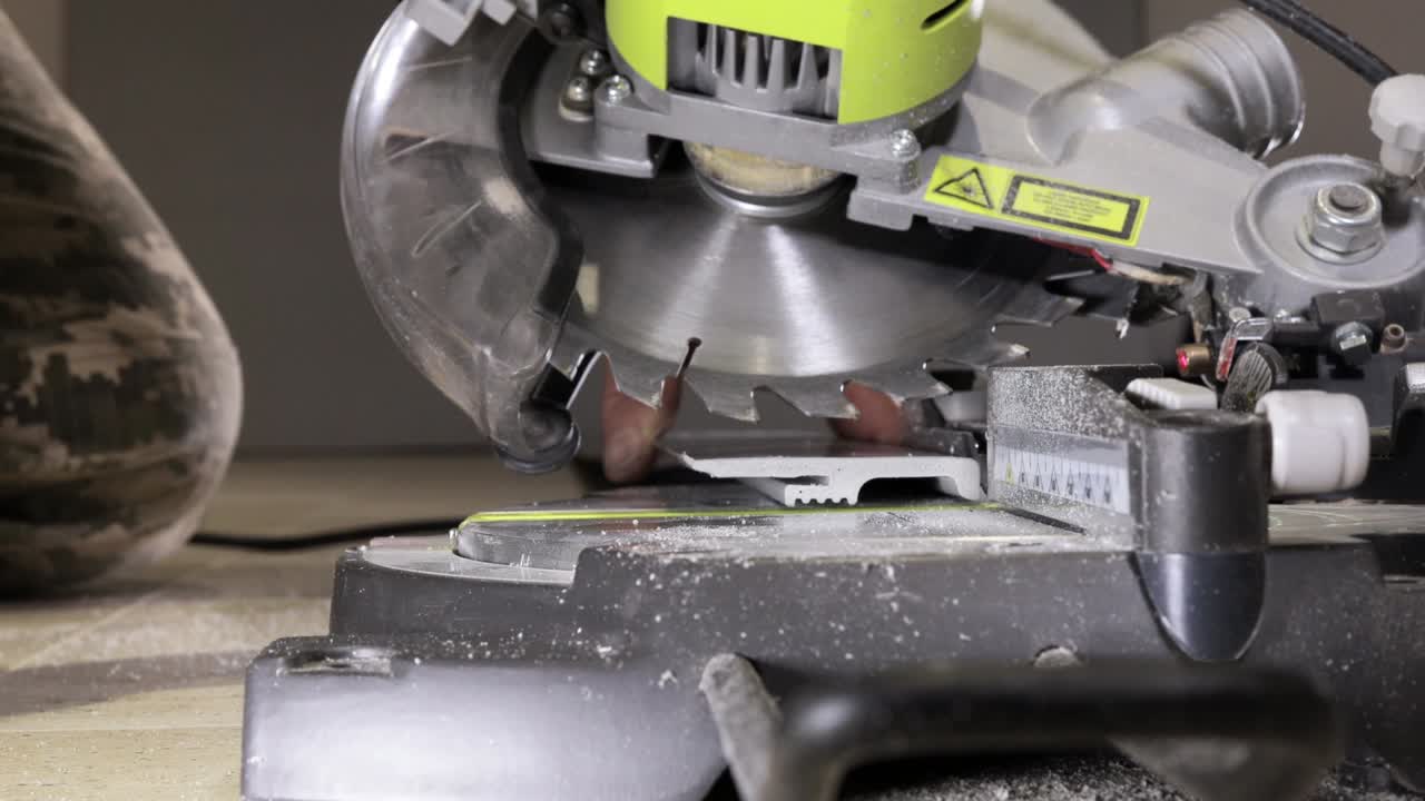 рабочий режет подставку на круговой пиле перед установкой.