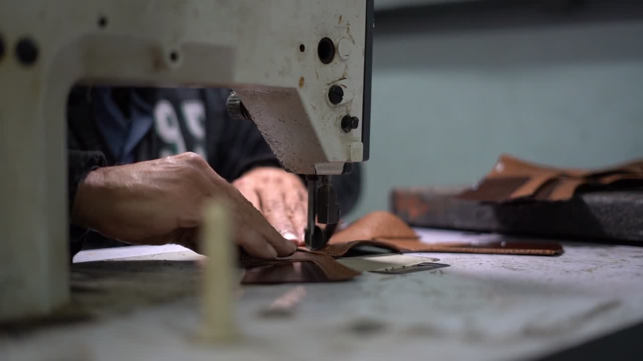 a craftsman handmade a bag by Sewing machine, close up shot, insert shot