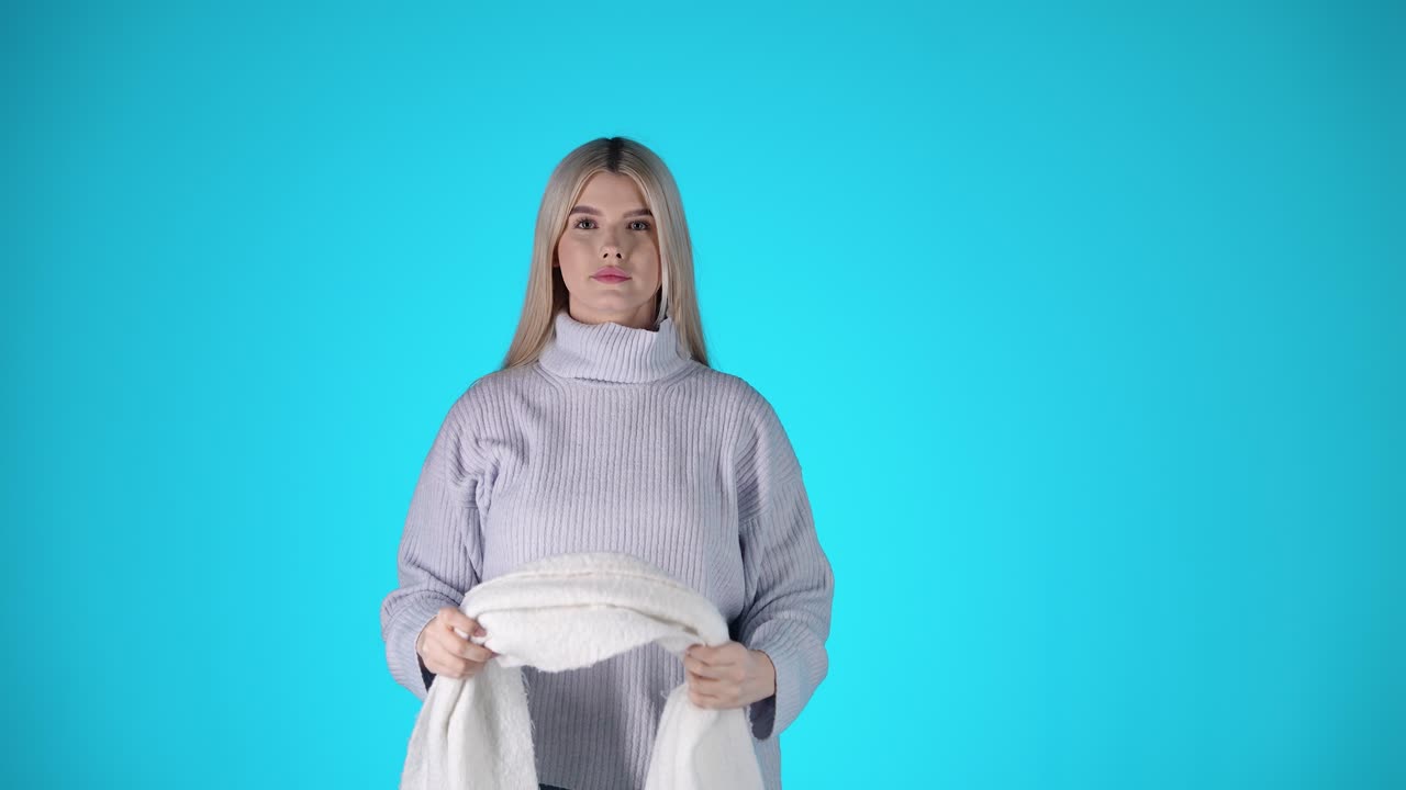 Young Blonde Woman Wears a Grey Woolen Scarf, Winter Clothing, Studio Portrait