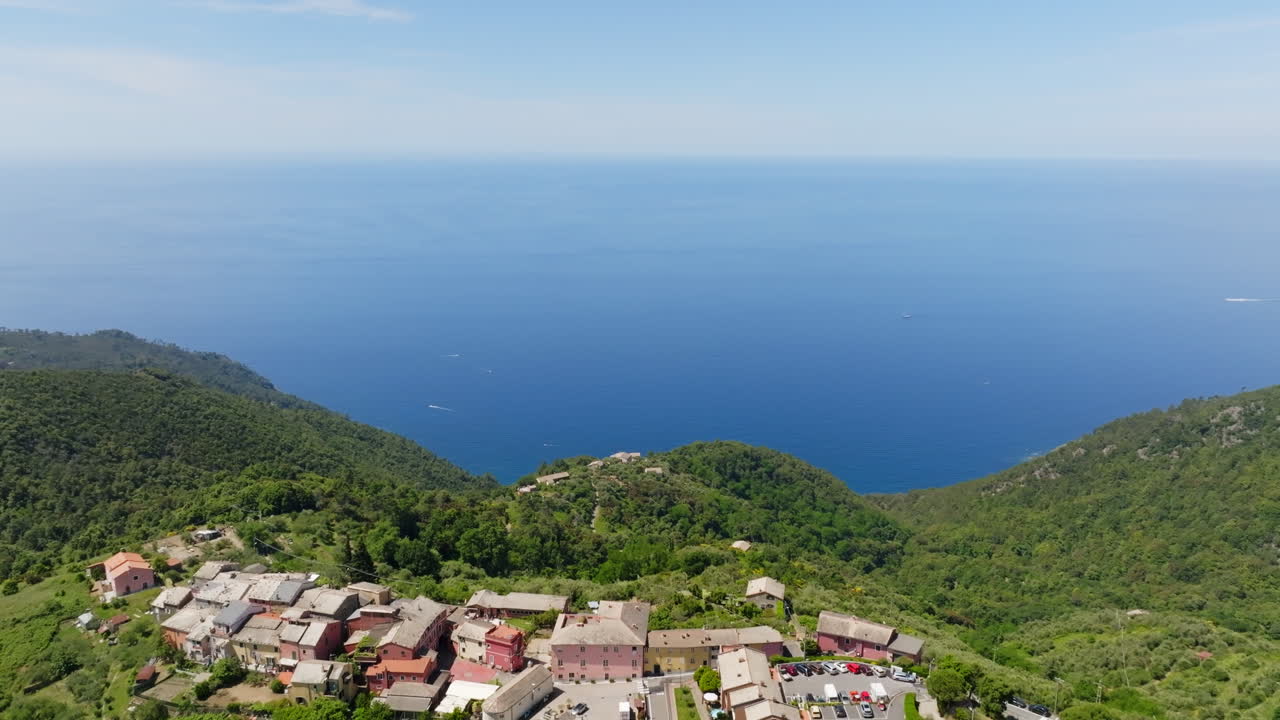 Aerial tilt shot around the Montaretto town, toward the sea, in Liguria, Italy