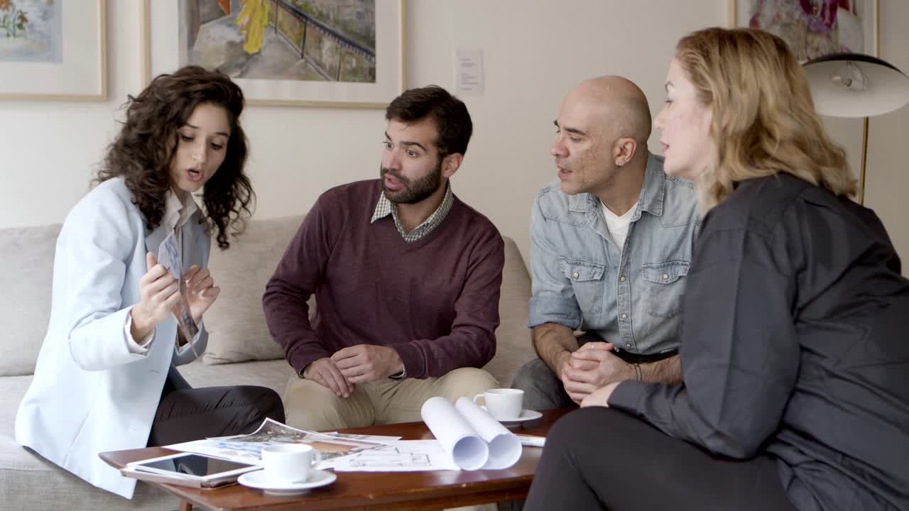 dueños reflexivos hablando con el diseñador de interiores