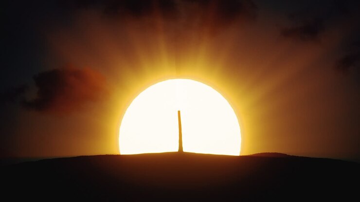 Sunrise or Sunset Over a Hill with a Tree Silhouette
