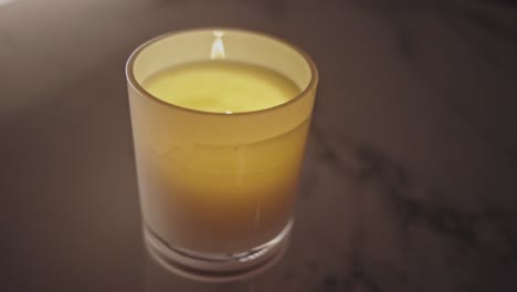 aromatic candle lit in a glass candle holder