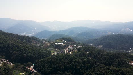 Cinematic-drone-flight-over-silhouetted-forest-hill-landscape-in-Asia