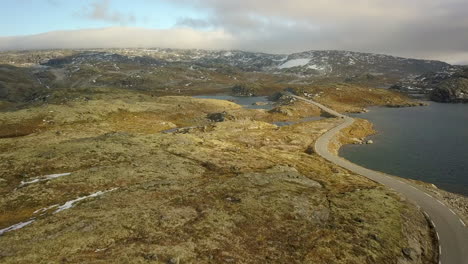 Aerial-View-of-an-Empty,-Narrow-Road-on-a-Barren-Mountain-in-Norway