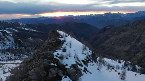 vivid sunset colors over italian alps landscape, snowy terrain of val camonica