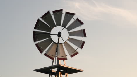 a small windmill turning in the light of the evening sun and breeze