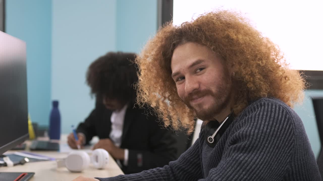 Happy creative businessman using computer in office