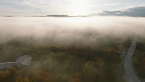 flying through misty clouds over autumn trees in sherbrooke, quebec canada