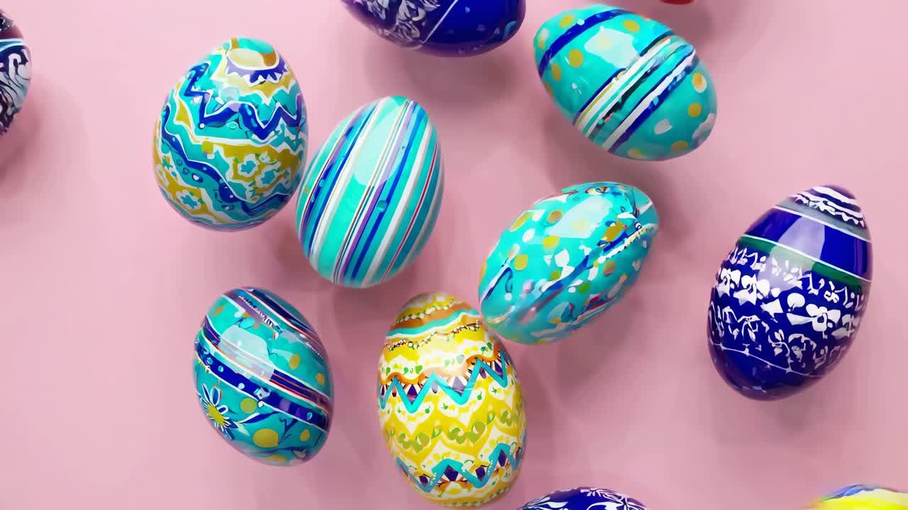 Top-down view of colorful, patterned Easter eggs on a pink background, showcasing vibrant designs