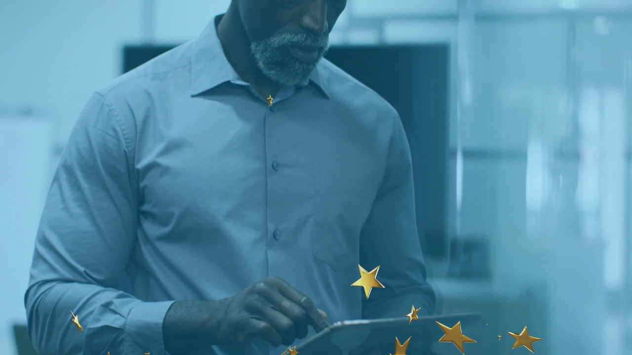 Elderly man using tablet with star animation overlay in office setting