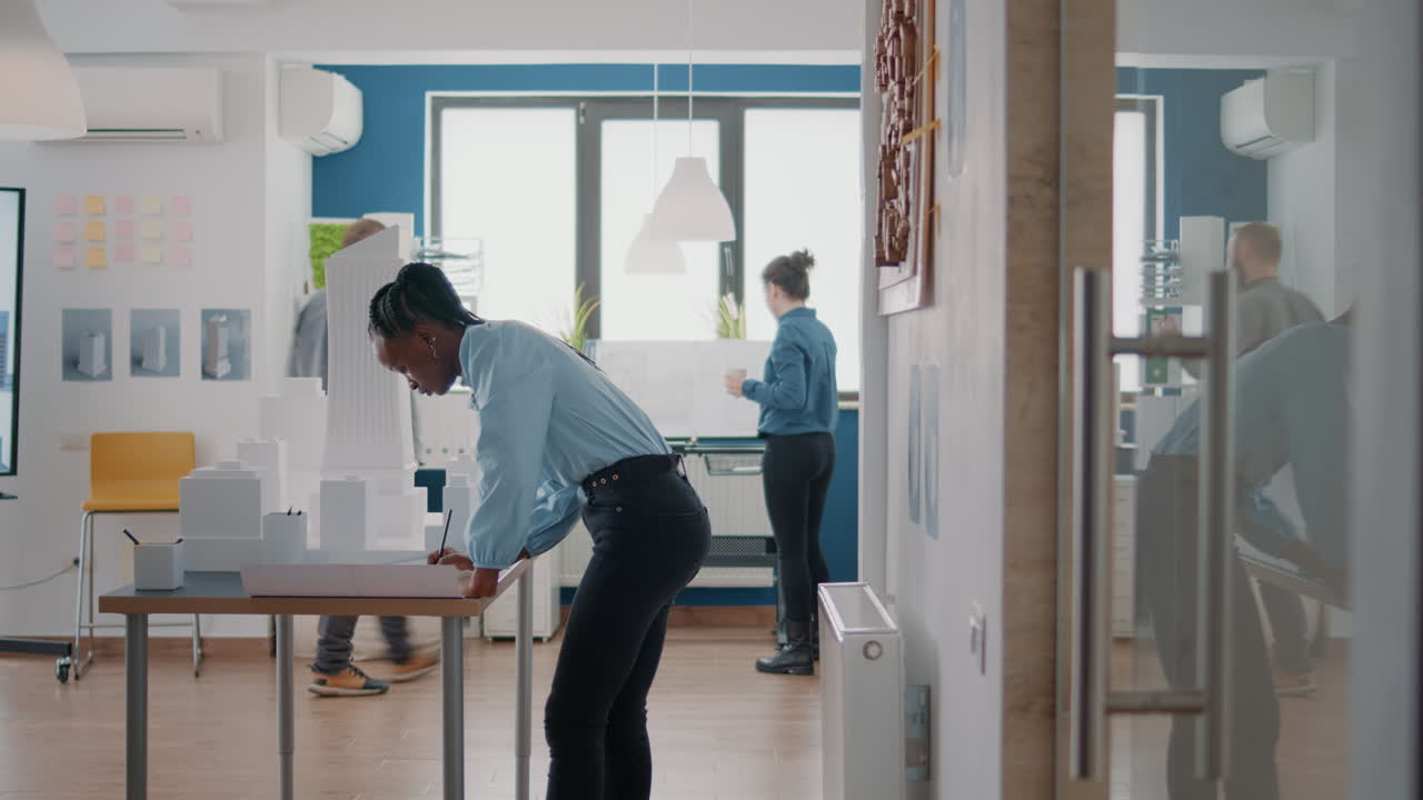 Architect Working on Building Model in Office