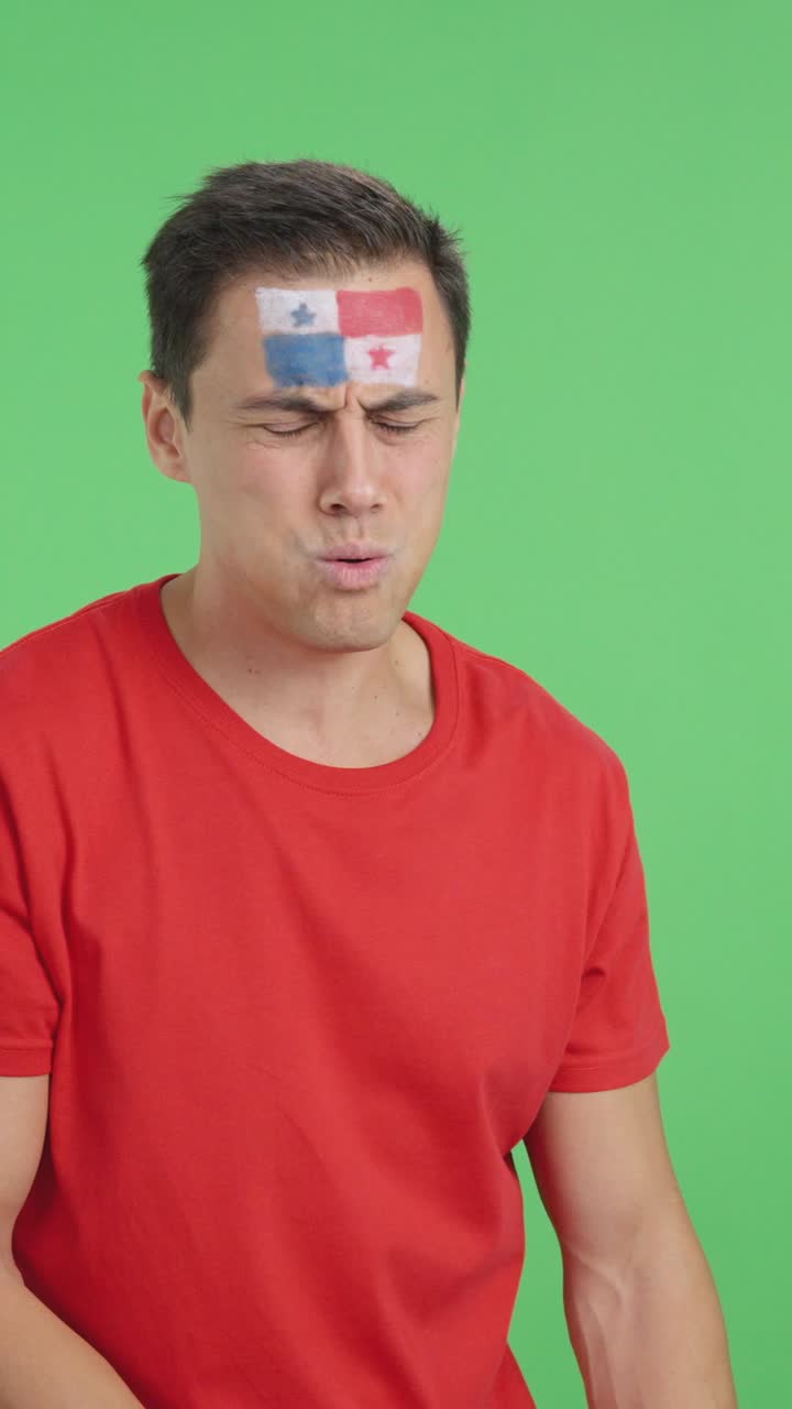 Nervous man cheering for Panama during a match looking away