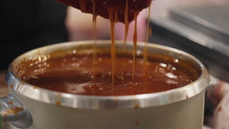 dipping sausages in sauce