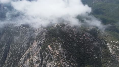 Cloudy-mountains-aerial-drone-shot-Thermessos,-Antalya-in-Turkey-above-clouds