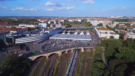 Beautiful-aerial-top-view-flight-tracks-yellow-suburban-train-Platform-S-Bahn-Station-bridge,-Berlin-mitte-summer-2023