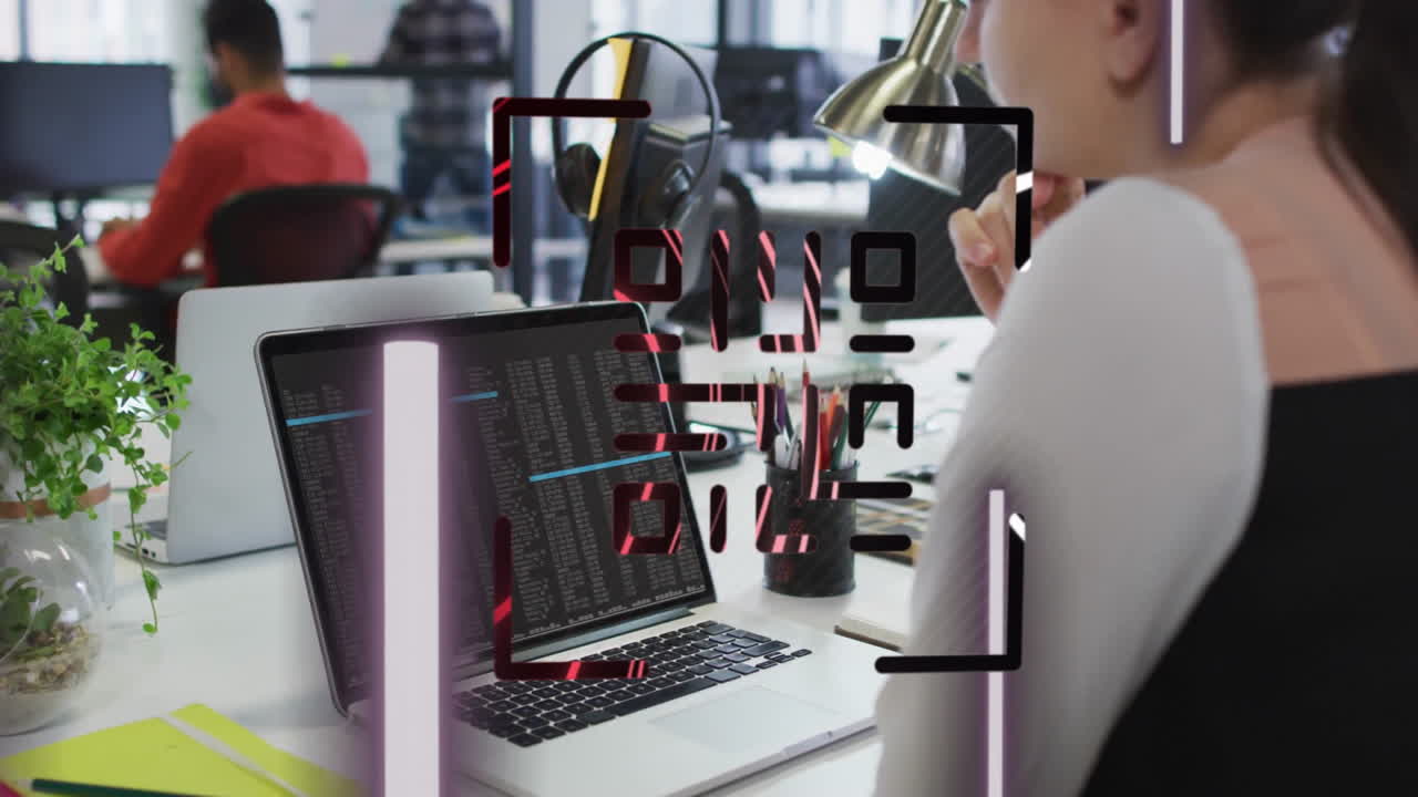 Person working on laptop with data processing animation over office environment