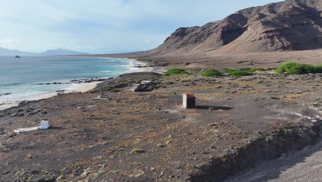 Aerial-View-of-Abandoned-Buildings-and-Beach-on-Uninhabited-Volcanic-Island,-Santa-Luzia,-Cape-Verde