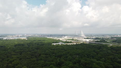 4K Aerial Drone View of Windsor Ontario Skyline Surrounded by Dense Forest