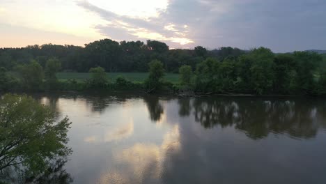 sunrise over a river with lush forest