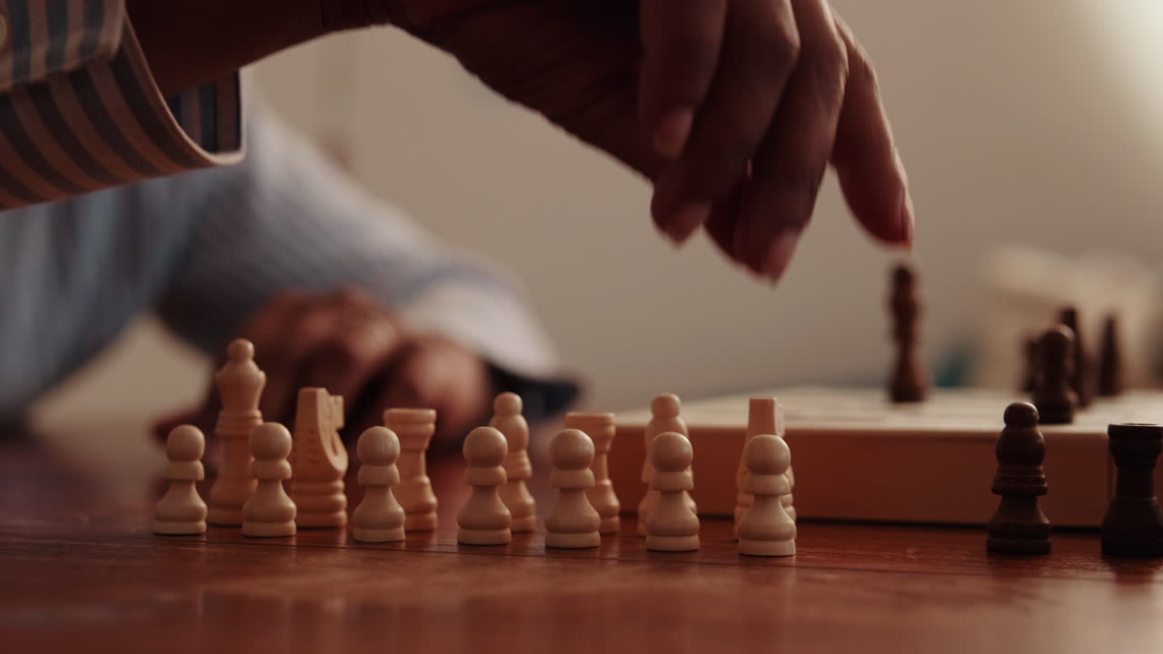Setting Up White Chess Pieces on a Wooden Table