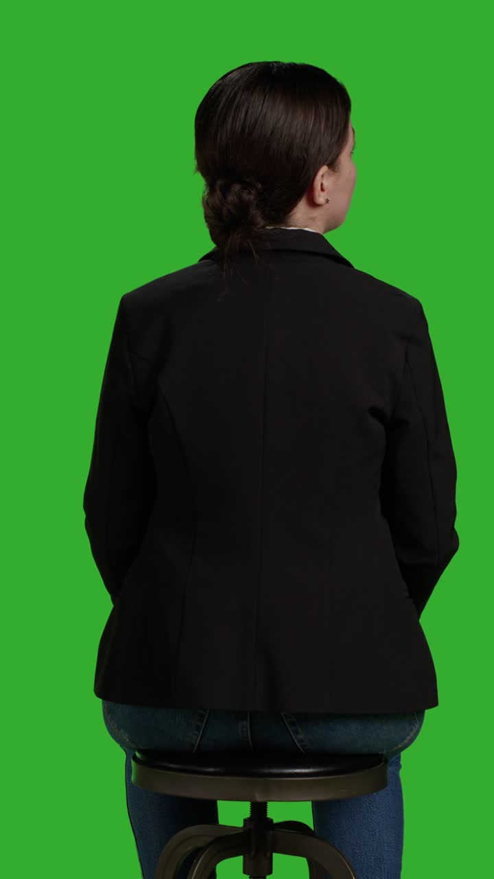 Vertical video: Back view close up of female manager waiting on chair