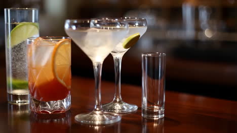 assortment of cocktails and drinks on a bar counter