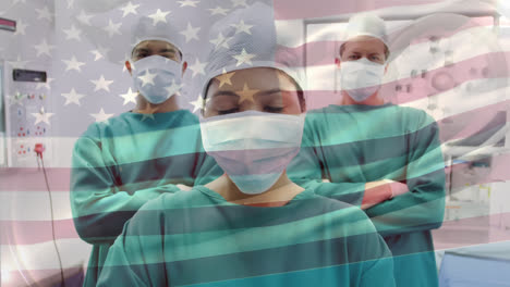 animation of flag of united states of america waving over surgeons in operating theatre