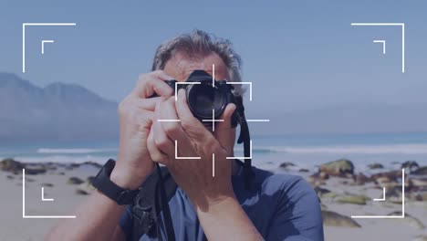 Camera-user-interface-frame-and-focus-screen-over-caucasian-senior-man-by-the-sea-taking-photos