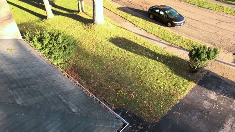 A-front-yard-lightly-populated-with-fallen-leaves-in-Autumn