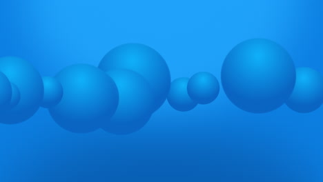 animation of variable size large blue spheres animation moving across the view from left to right on a gradient background