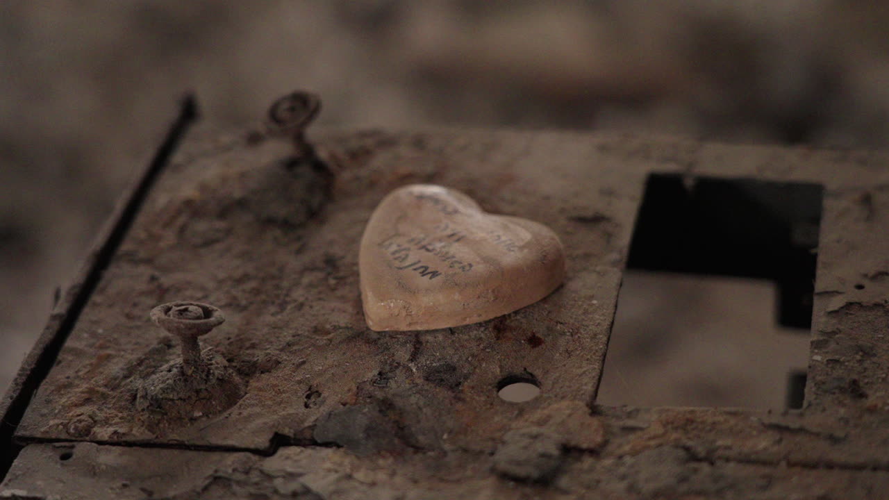 Close up of a stone shaped like a heart inside destroyed room in Kibbutz Nir Oz