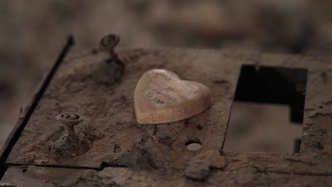 close up of a stone shaped like a heart inside destroyed room in kibbutz nir oz
