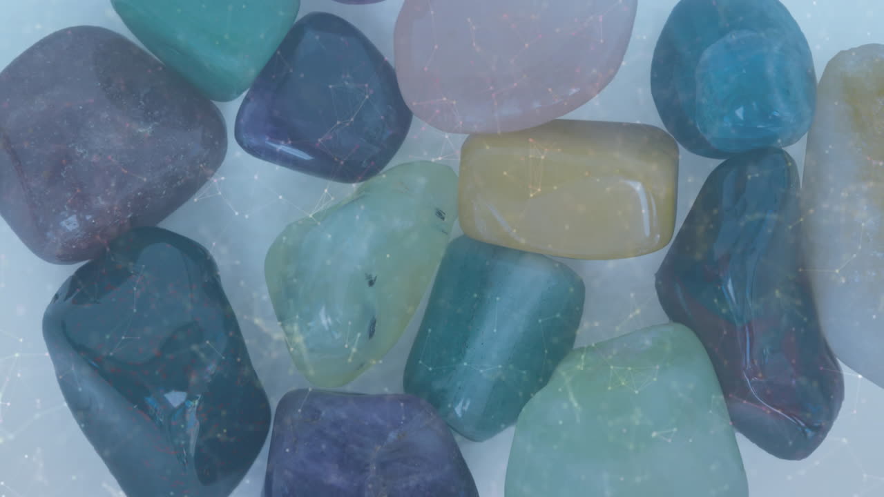 Polished tumbled stones forming mosaic, highlighting glossy translucent sheen under soft lighting