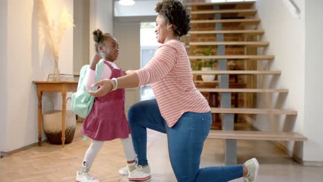 happy african american mother and daughter hugging at home, slow motion
