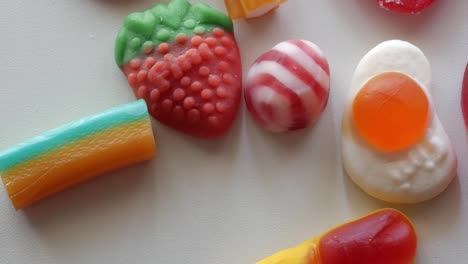 Panning-above-movement-mixed-sweets-and-jellies-on-a-white-table