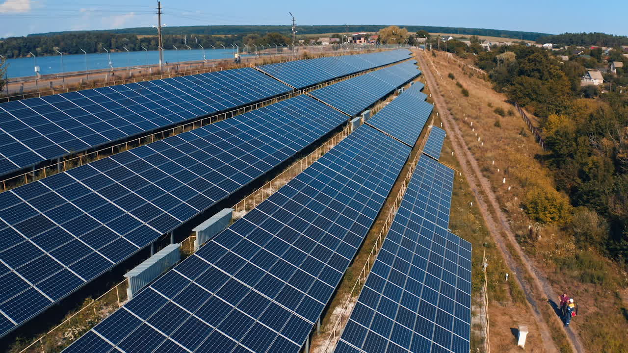 Solar panels in the countryside. Blue photovoltaic panels get clean energy from the sun. Electricity innovations. Aerial view.