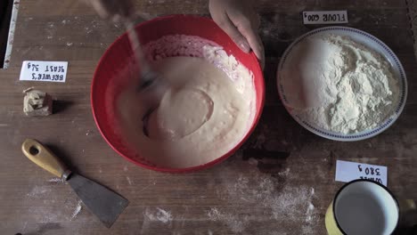 mix water and salt for bread recipe over the wood with label ingredient making italian pizza