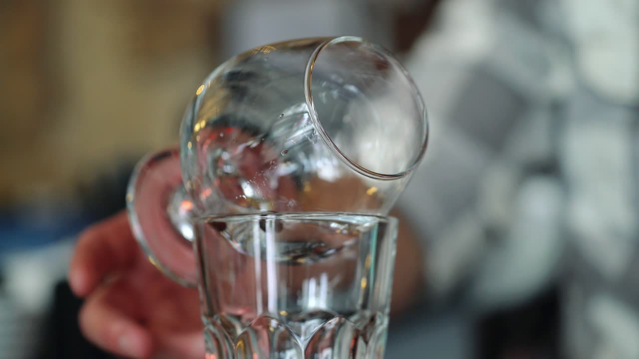 Bartender burning Sambuca at the bar. Cocktail preparation process.