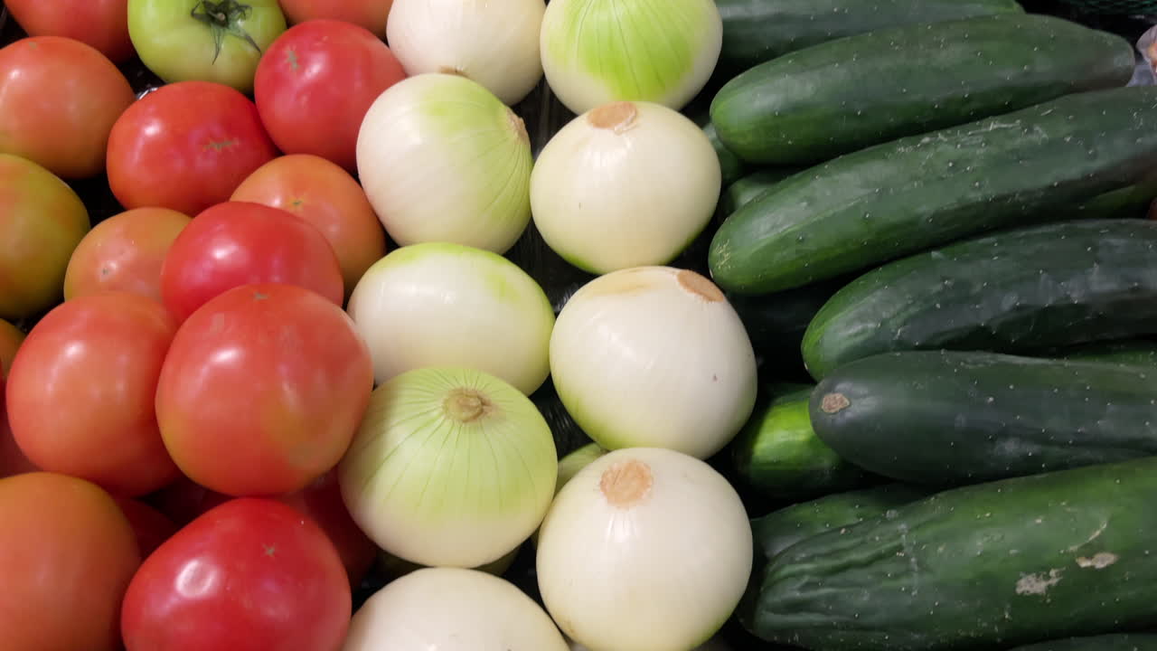 Fresh vegetables including tomatoes, onions and cucumbers