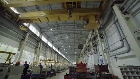 large industrial manufacturing facility with workers and machinery