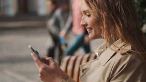 caucasian female student online shopping on smartphone outdoors.