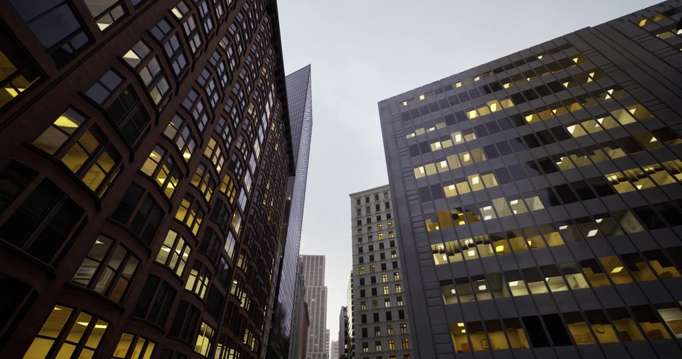 Edifici in vetro e acciaio dominano un trafficato corridoio urbano di notte