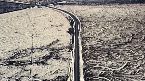 drone showing beautiful patterns in the landscape below, on snowy conditions