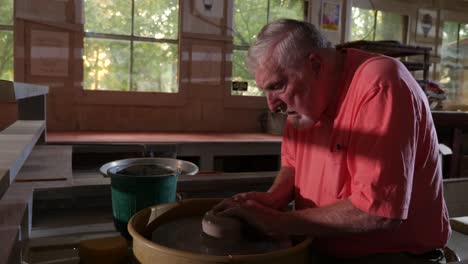 artist making pottery in a workshop