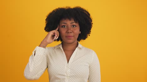 happy attractive african young woman dancing isolated on yellow background.cheerful pretty girl happy with tablet notebook online music smiling and moving body follow music with positive.