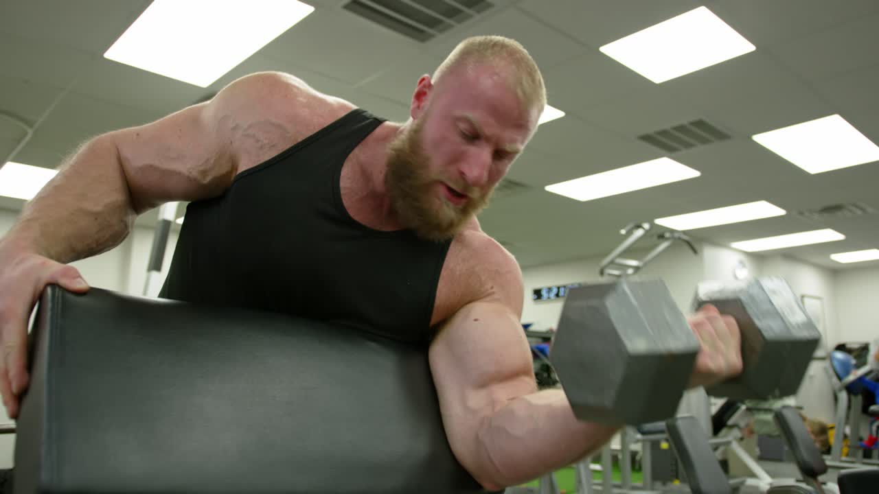 Strong bodybuilder lifting weights. Athletic person effort