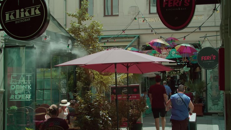 People walking in a street with restaurants and cafes in the city