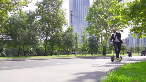 Eco-friendly-businessman-drives-electric-scooter.